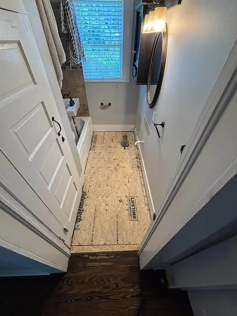 Narrow bathroom with a new subfloor panel installed
