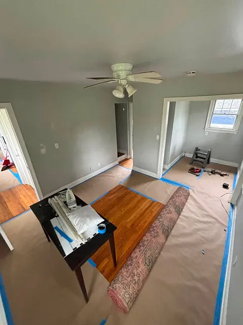 Living room with protective floor covering taped down during renovation