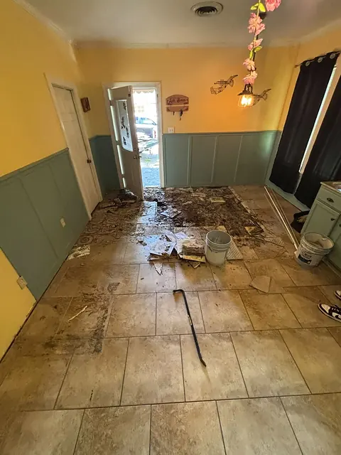 Old floor tile being removed near a back door