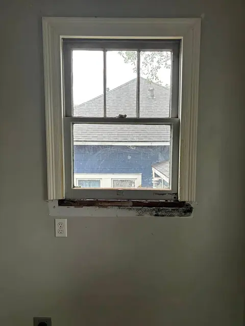 Window with a rotted sill before repair